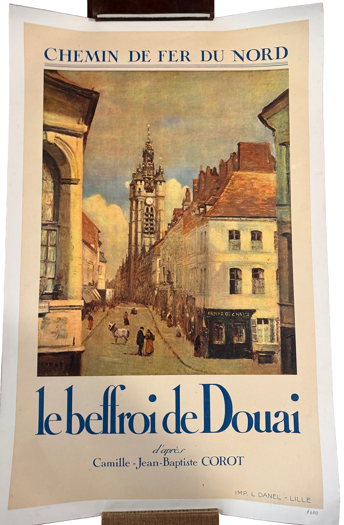 Vintage travel poster for the Douai bell tower, featuring a painted street scene with historic buildings and a tall bell tower. The poster has a cream background with blue text reading 'CHEMIN DE FER DU NORD' at the top and 'le belfroi de Douai' at the bottom.